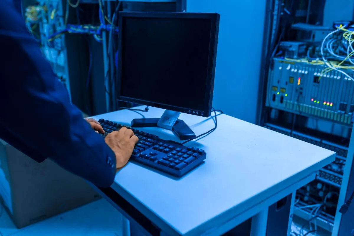Yemaar engineer working on network infrastructure in a server room